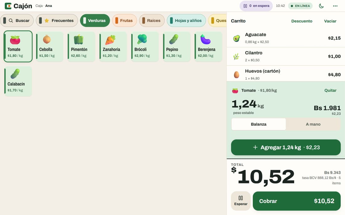 Caja de Cajón en una computadora: el tomate pesa 1,24 kg en la balanza, el carrito suma $10,52 y debajo aparece el total en bolívares con la tasa BCV.